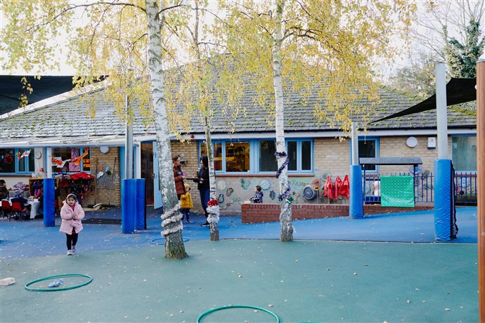 Spring day, Low Hall playground, silver birch trees, single-storey nursery building in the background