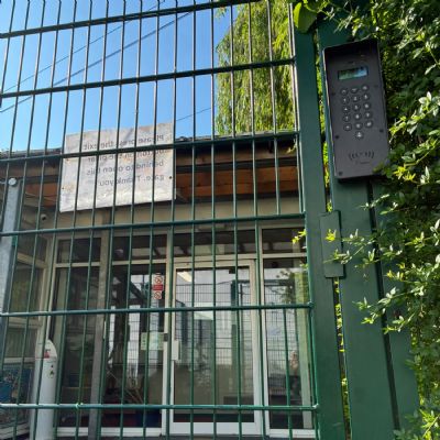 The green gate with the buzzer