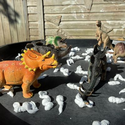 Close up of dinosaurs wading through foam