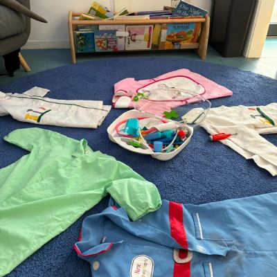 Dressing up clothes laid out on the 2-year-old room floor